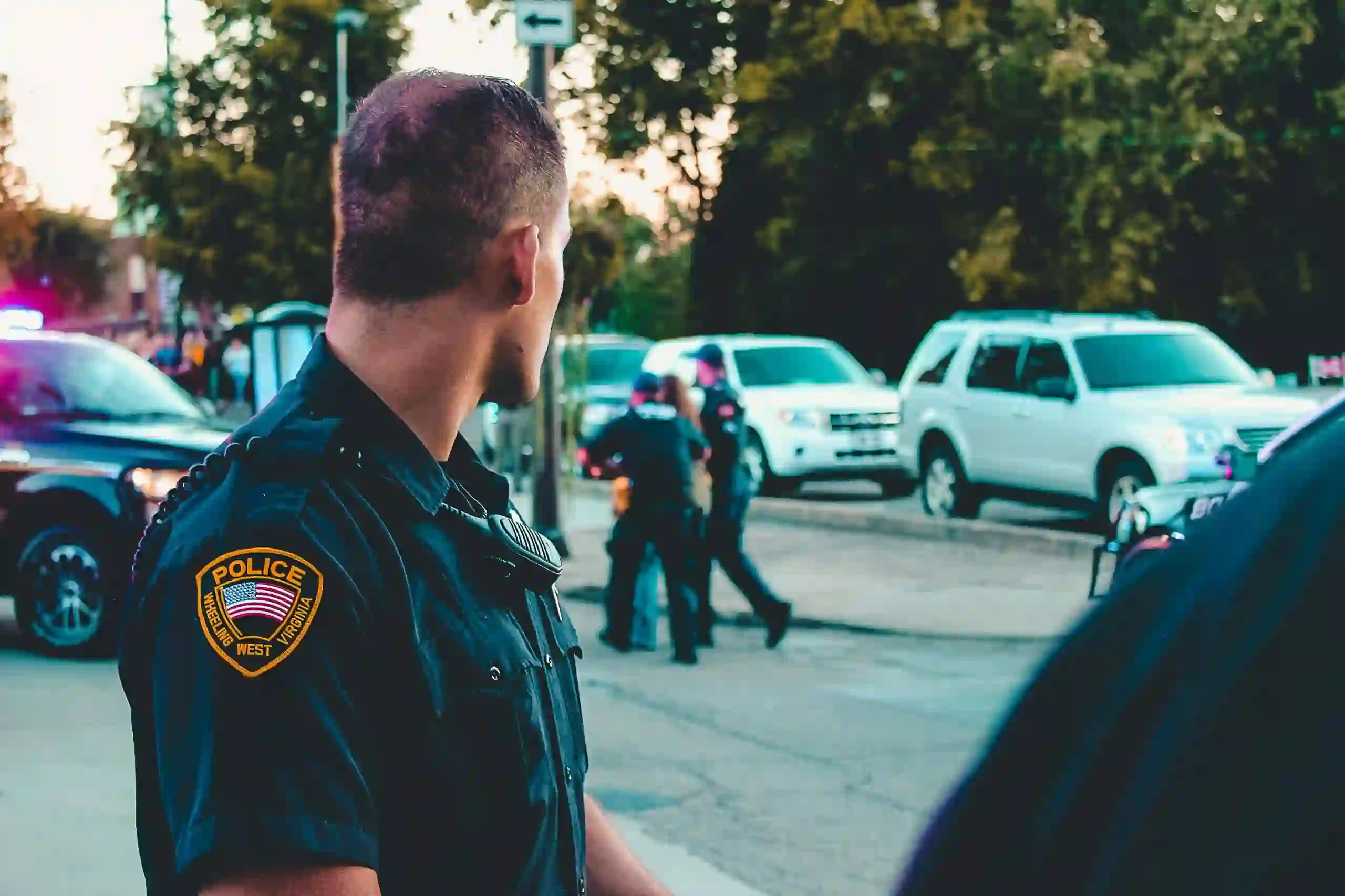 A police officer looking at other officers walking away